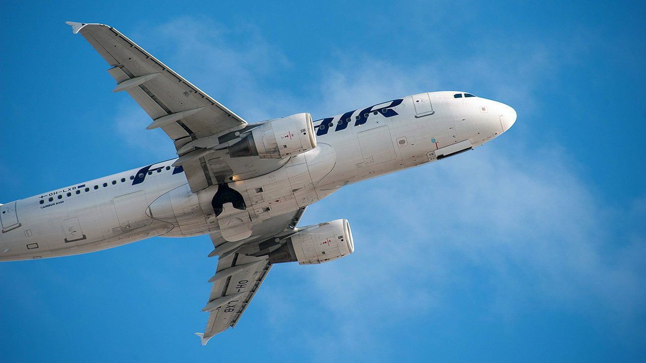 Finnair Airbus aircraft climbing after departure at Helsinki-Vantaa airport.