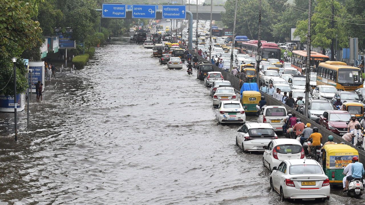 Commuters navigate through through a traffic jam due to water-logging after heavy monsoon rain in New Delhi, India
