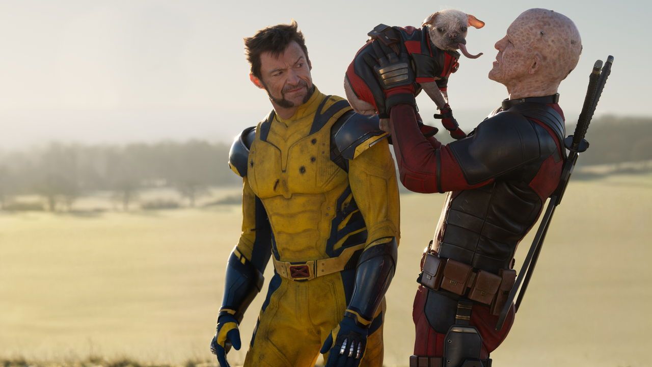A film still with Hugh Jackman as Wolverine/Logan, Dogpool, and Ryan Reynolds as Deadpool/Wade Wilson in 20th Century Studios/Marvel Studios' DEADPOOL & WOLVERINE.