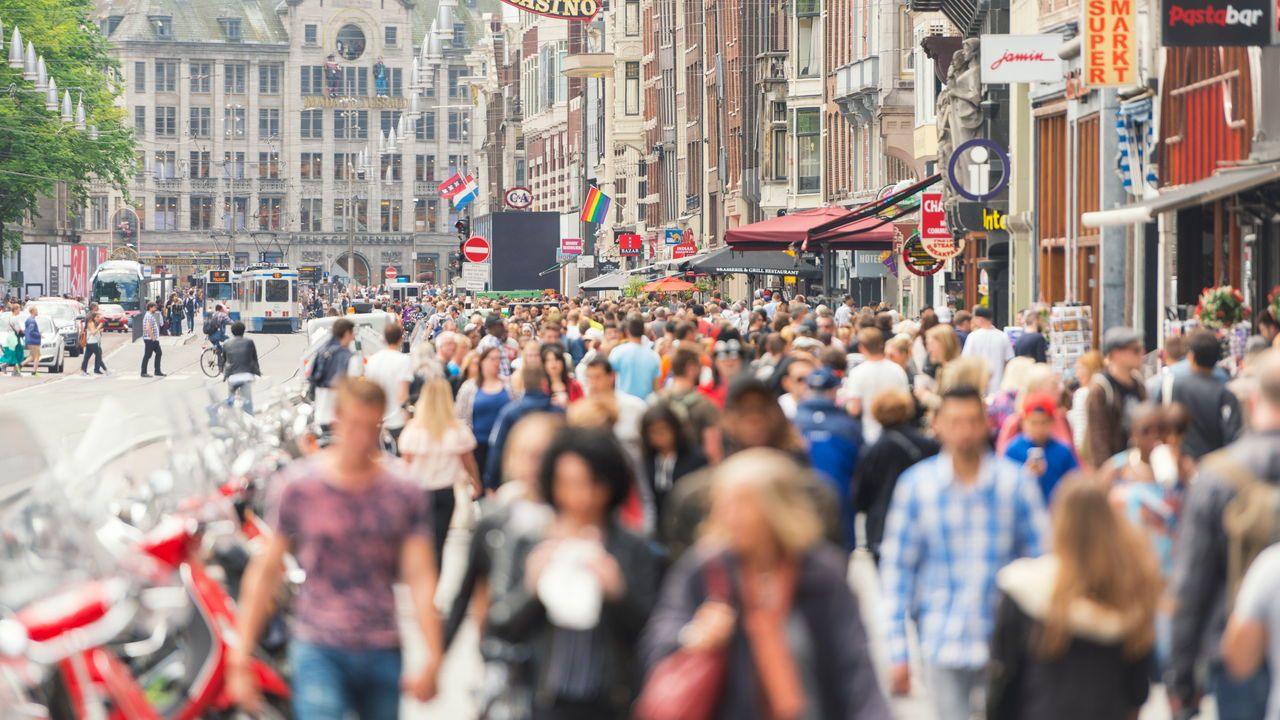 Crowds on the Damrak in Amsterdam, the Netherlands