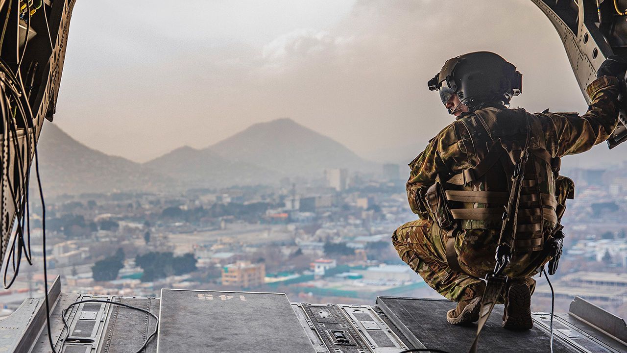 U.S. Soldier surveys the back of a CH-47 Chinook during flight over Kabul, Afghanistan.