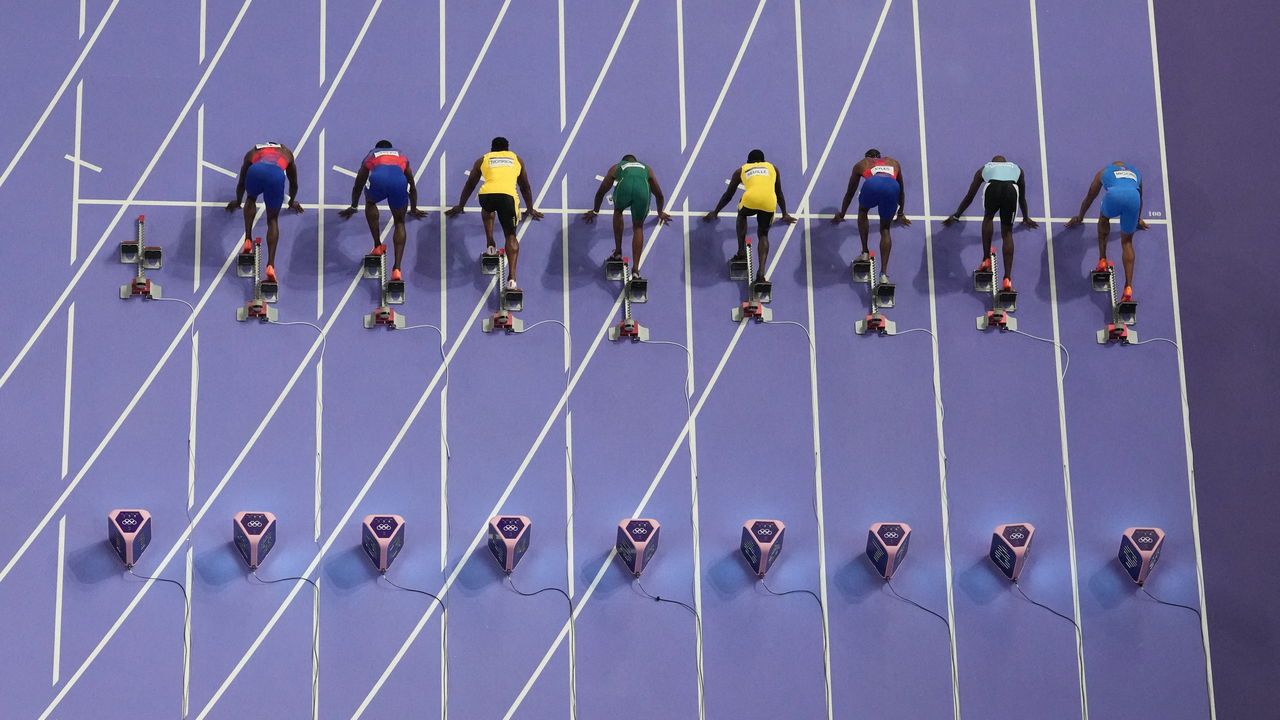 General view of the athletes in the blocks at the start of the race. Paris 2024 Olympics - Athletics - Men's 100m Final - Stade de France, Saint-Denis, France.